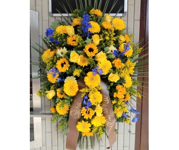 Cuscino di fiori recisi dai toni gialli e blù